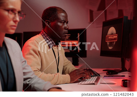 IT manager typing on computer keypad IT manager typing on computer keypad 121482043