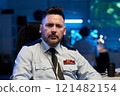 Serious officer in light blue uniform 121482154