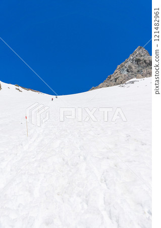 Climbing Mount Yari in the early summer with snow remaining in the mountains of the Northern Alps - Mount Yari and the mountain lodge 121482961