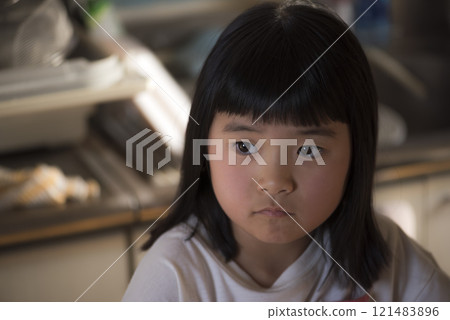 The expression of a girl sitting alone in a quiet room The expression of a girl sitting alone in a quiet room 121483896