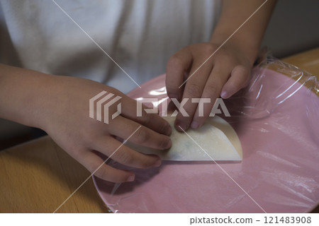 Children's hands making dumplings at home 121483908