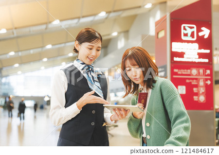 Image of a cabin attendant giving directions at the airport Image of a cabin attendant giving directions at the airport 121484617