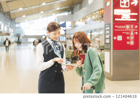 Image of a cabin attendant giving directions at the airport Image of a cabin attendant giving directions at the airport 121484618