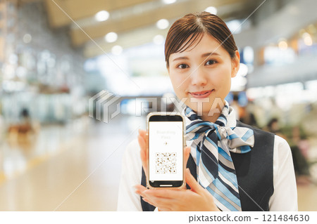 Image of a cabin attendant giving directions via smartphone Image of a cabin attendant giving directions via smartphone 121484630