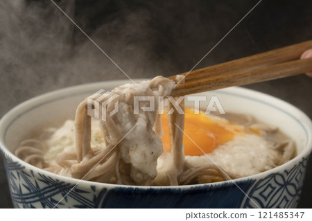 Picking up grated yam soba noodles with chopsticks Picking up grated yam soba noodles with chopsticks 121485347