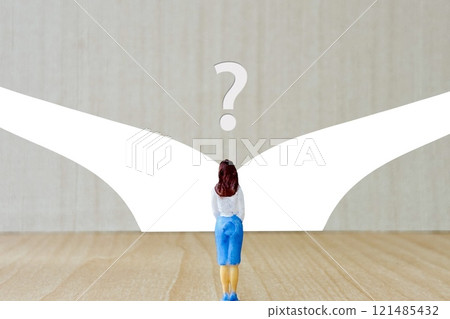 Back view of a woman lost in her laundry at a crossroads 121485432