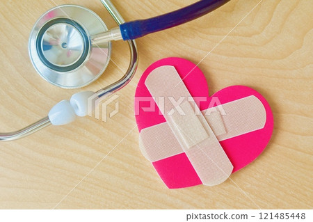 Heart with bandaid and stethoscope 121485448