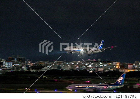 An ANA plane landing at Fukuoka Airport at night and preparing to take off An ANA plane landing at Fukuoka Airport at night and preparing to take off 121485793
