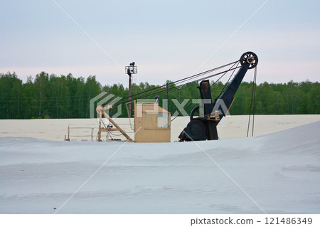 Sand quarry with excavator inside 121486349