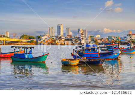 Traditional Vietnamese fishing boats, ships and vessels at the fishing seaport Vinh Truong on the sea in Nha Trang in Vietnam 121486652