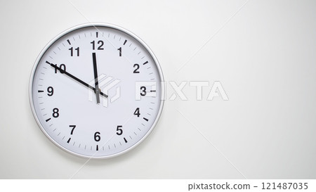 Minimalist White Clock with Silver Frame Striking 23.50/11.50 on White Background. Perfect for Time Management and Corporate Campaigns 121487035