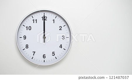 Minimalist White Clock with Silver Frame Striking 12.00/00.00/24.00 on White Background. Perfect for Time Management and Corporate Campaigns 121487037