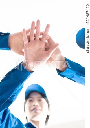 Logistic employees who are united by teamwork Logistic employees who are united by teamwork 121487460