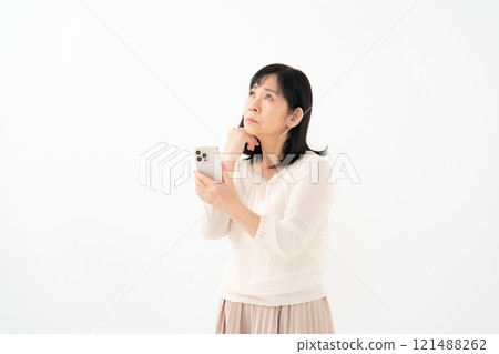 Senior woman, smartphone, worries 121488262