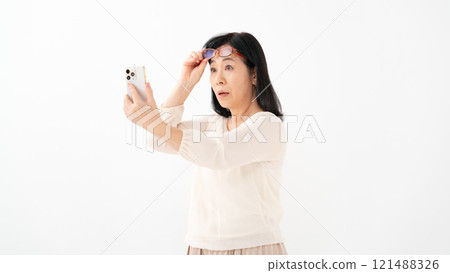 Female senior smartphone presbyopia Female senior smartphone presbyopia 121488326