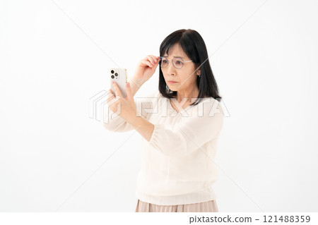 Female senior smartphone presbyopia Female senior smartphone presbyopia 121488359