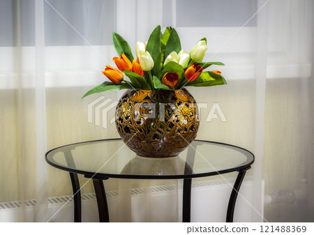 Flowers on a glass table Flowers on a glass table 121488369