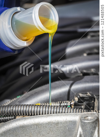 Pouring oil in the engine 121488505