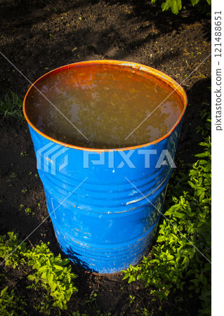 A garden barrel with water. 121488651