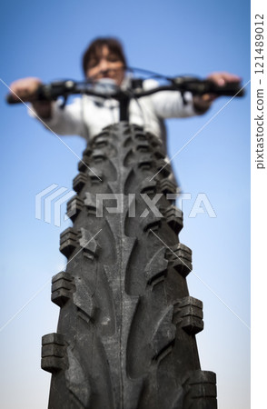 Woman on a bicycle Woman on a bicycle 121489012