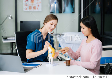 Female doctor using clipboard is delivering great news talk discuss results or symptoms with female patient 121489312