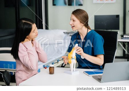 Female doctor using clipboard is delivering great news talk discuss results or symptoms with female patient 121489313