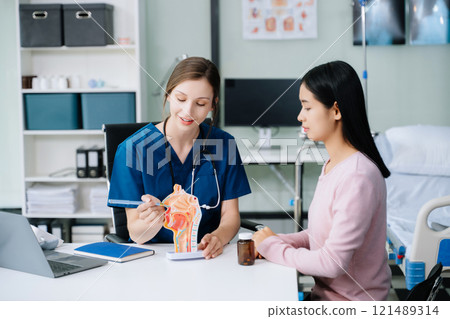Female doctor using clipboard is delivering great news talk discuss results or symptoms with female patient Female doctor using clipboard is delivering great news talk discuss results or symptoms with female patient 121489314