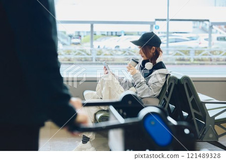 A woman in Y2K fashion waiting at the airport 121489328