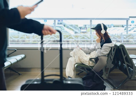 A woman in Y2K fashion waiting at the airport 121489333