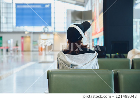 A woman in Y2K fashion waiting at the airport 121489348