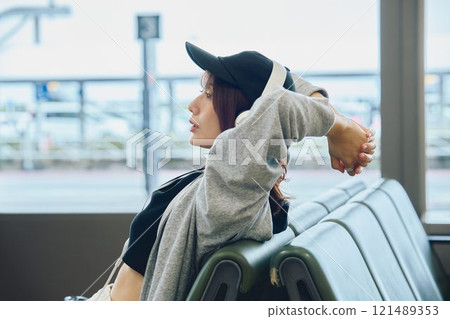 A woman in Y2K fashion waiting at the airport 121489353
