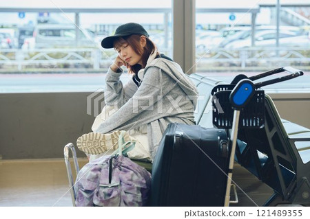 A woman in Y2K fashion waiting at the airport 121489355