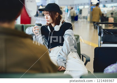 A woman in Y2K fashion waiting at the airport A woman in Y2K fashion waiting at the airport 121489367