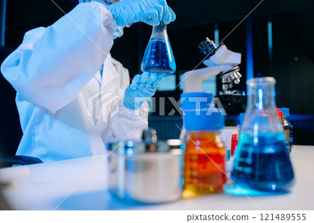 Female biotechnologist testing new chemical substances in a laboratory. Female biotechnologist testing new chemical substances in a laboratory. 121489555