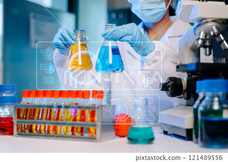 Female biotechnologist testing new chemical substances in a laboratory. Female biotechnologist testing new chemical substances in a laboratory. 121489556