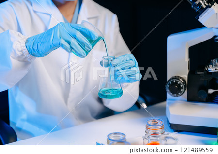Female biotechnologist testing new chemical substances in a laboratory. 121489559
