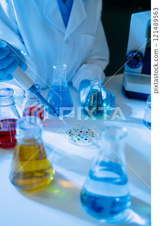 Female biotechnologist testing new chemical substances in a laboratory. Female biotechnologist testing new chemical substances in a laboratory. 121489563