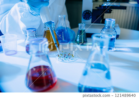 Female biotechnologist testing new chemical substances in a laboratory. 121489640
