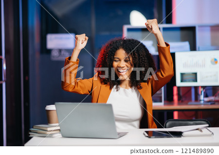 Business woman are delighted and happy with the work they do on their tablet, laptop at office. neon light in dark time. Business woman are delighted and happy with the work they do on their tablet, laptop at office. neon light in dark time. 121489890