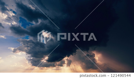 dark dramatic clouds in cloudy sky in a storm and rain at sunset dark dramatic clouds in cloudy sky in a storm and rain at sunset 121490544