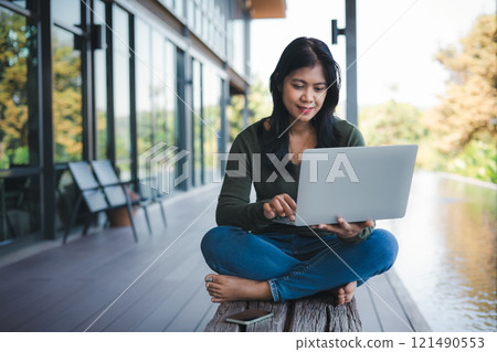 Business concept. Working away from the office. Businessman analyzing company performance graph to generate profit and growth, Businesswoman typing on laptop computer keyboard in coffee shop. Business concept. Working away from the office. Businessman analyzing company performance graph to generate profit and growth, Businesswoman typing on laptop computer keyboard in coffee shop. 121490553