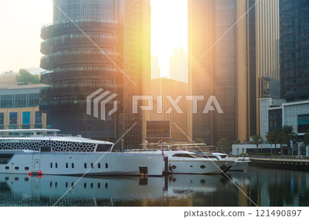 Morning rays of sun fall on yachts in the marina Morning rays of sun fall on yachts in the marina 121490897