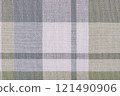 Checkered fabric in gray, white, and green as a background. Kitchen towel, tablecloth. 121490906