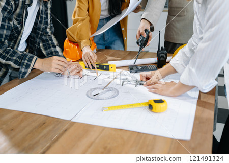 Creative architect projecting on the big drawings with architectural project at construction site 121491324
