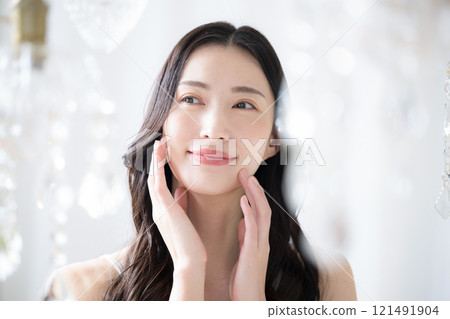 A beauty image of a beautiful young woman with a sparkling background and blurred front 121491904