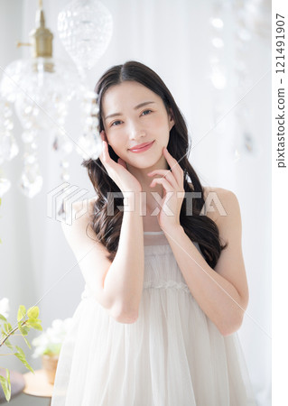 A beauty image of a beautiful young woman with a sparkling background and blurred front 121491907