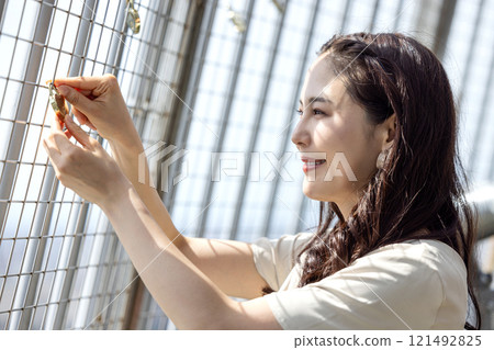 Woman putting a love padlock 121492825