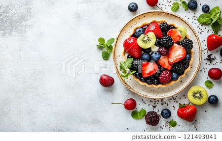 Various berries tart on a plate on light rustic background 121493041