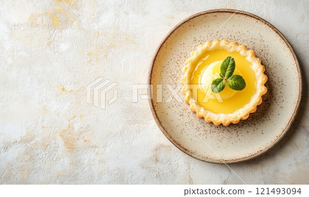 Lemon tartlets on a plate on light rustic background 121493094