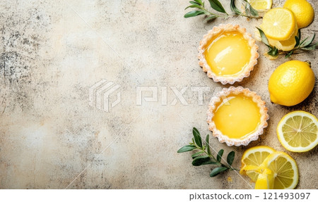 Lemon tartlets on a plate on light rustic background 121493097